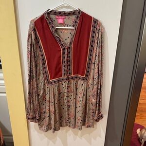 Woman Within Floral Tunic with Red and Purple Accents